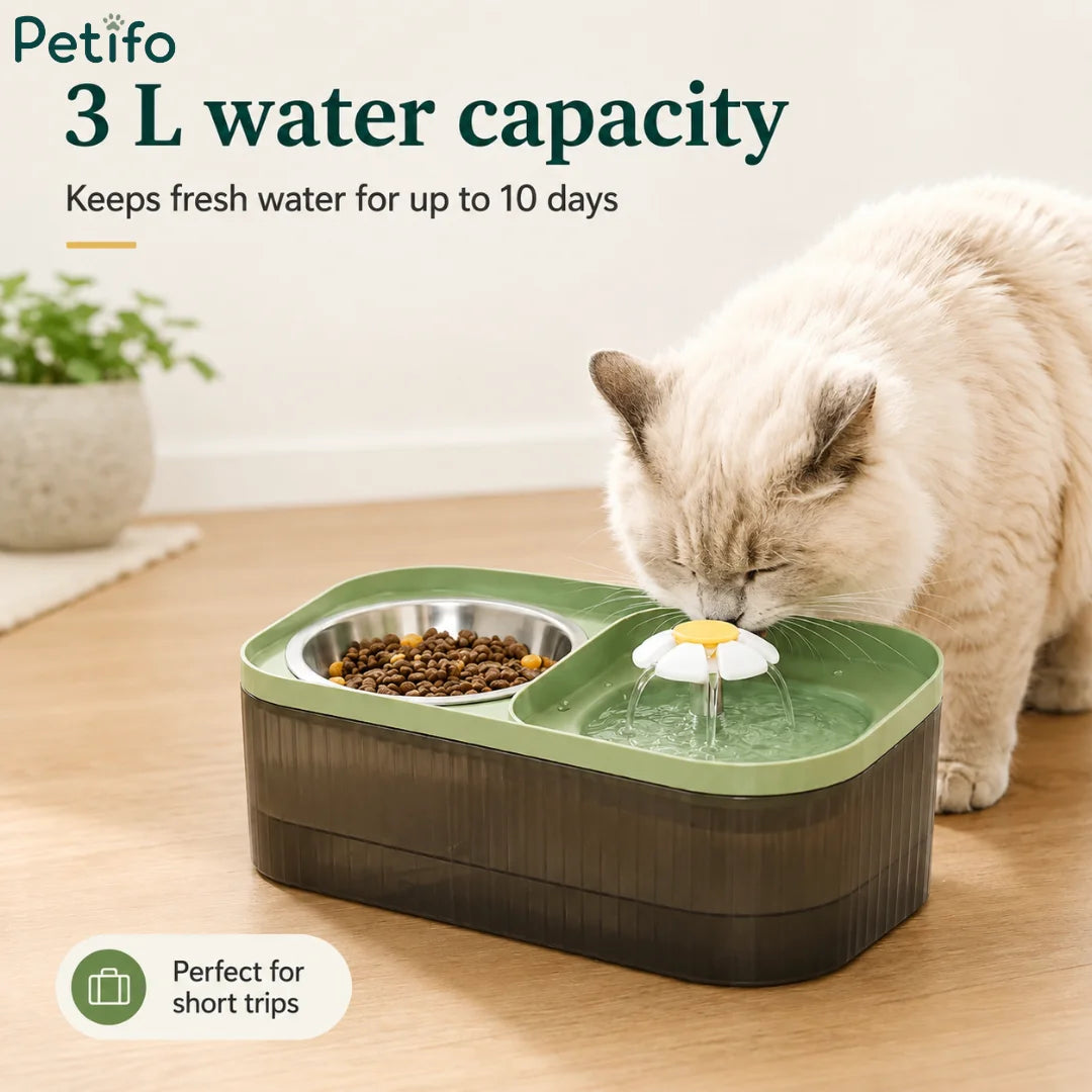 A white cat drinking from a 3L capacity green water fountain designed to keep fresh water available for up to 10 days.