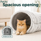 A fluffy gray cat tunnel featuring a spacious opening and an inset of a hanging toy ball.