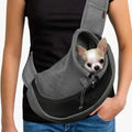 Small Chihuahua puppy safely resting inside a grey mesh hands-free pet sling carrier.