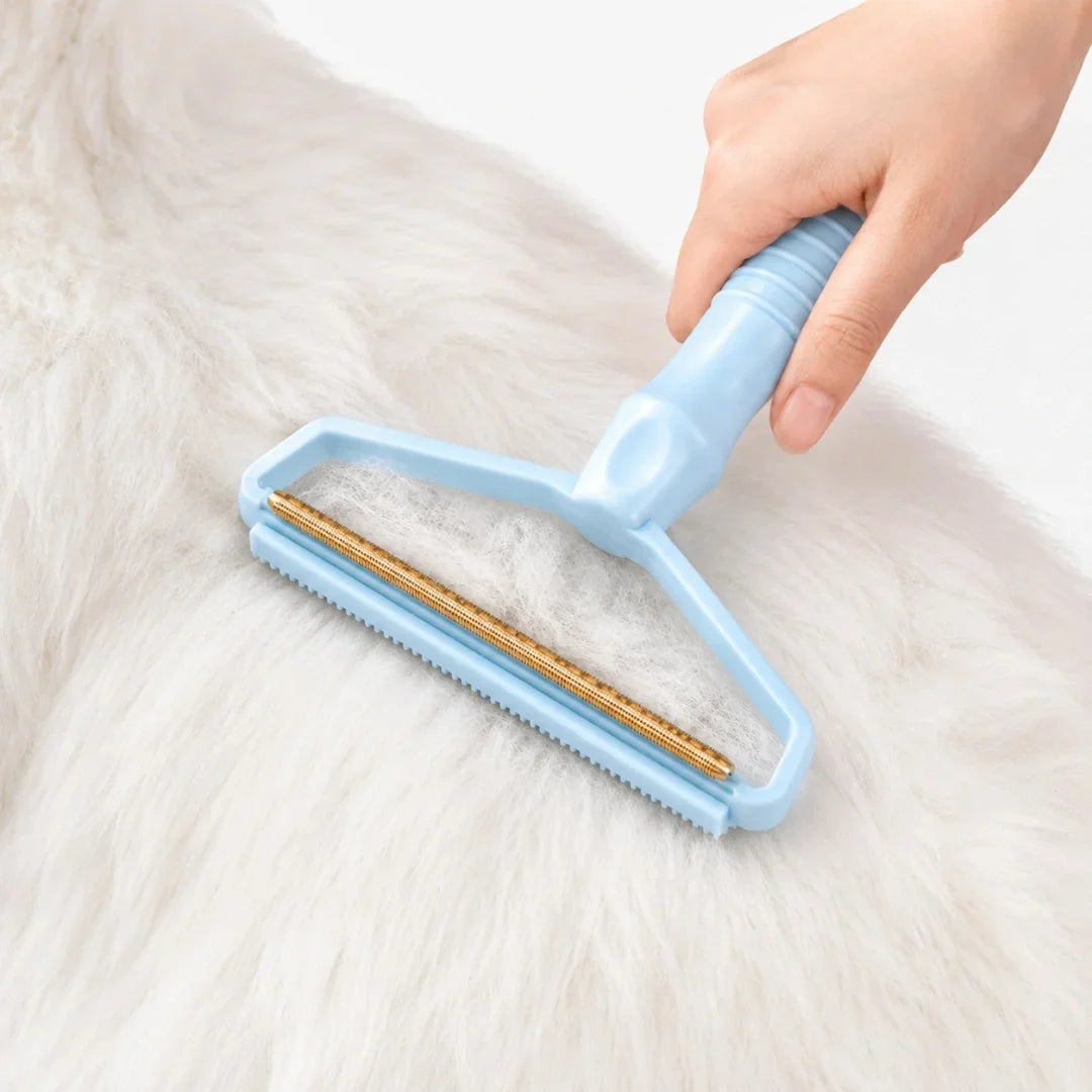 Blue pet hair remover tool gliding smoothly across a thick white coat of pet hair.