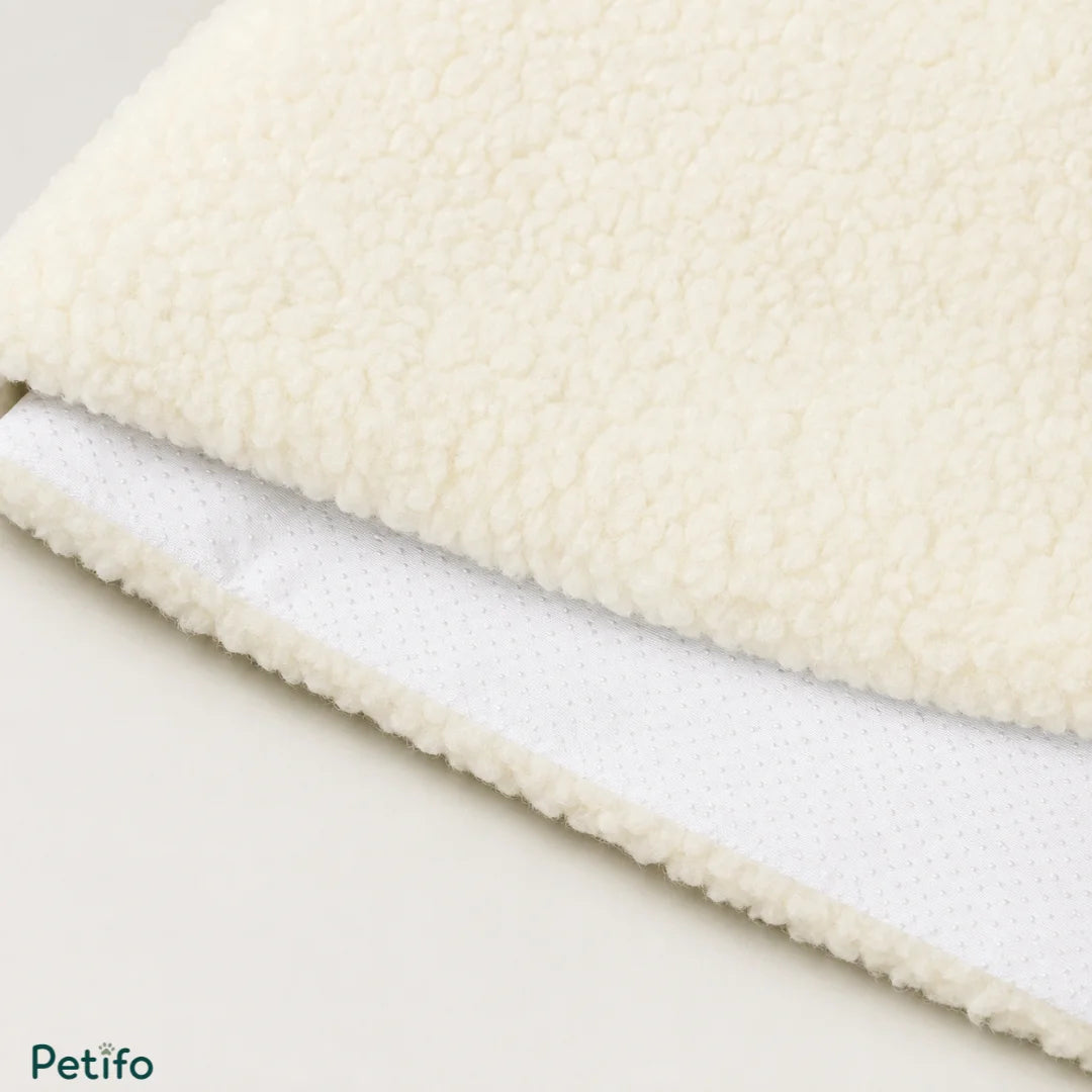 Macro texture shot of the soft, fluffy white fleece top surface and the dotted anti-slip bottom fabric of the mat.