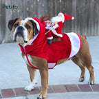 Bulldog wearing a Santa Claus riding a reindeer Christmas costume outdoors.