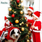 Kids and dogs celebrating Christmas wearing Santa Claus and reindeer costumes.