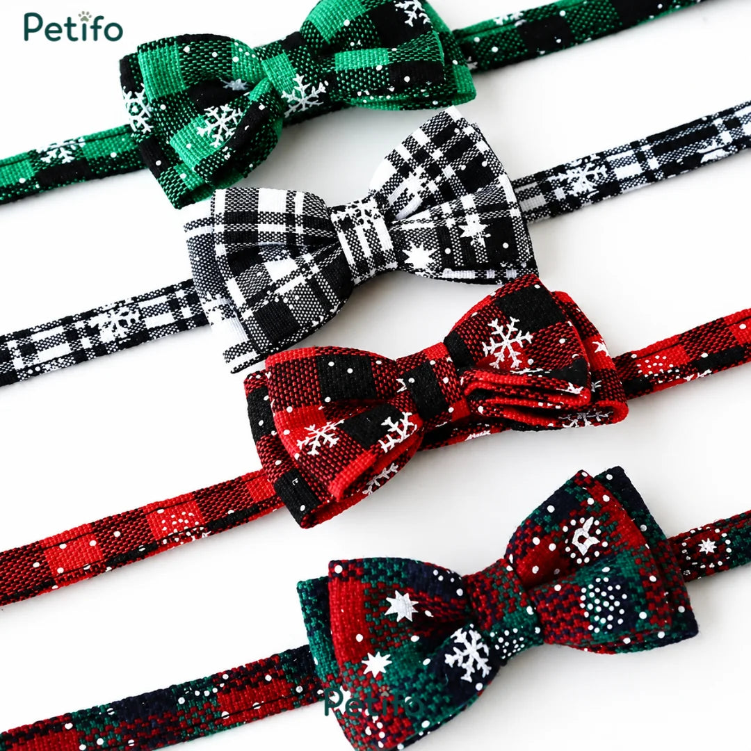 Close-up view of four different colored plaid Christmas cat collars with bow ties.