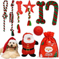 A collection of Petifo Christmas dog toys arranged on a white background, featuring various red and green braided rope toys, chew toys, a spiked red ball, a squeaky Santa plush toy, a dog holding a bone toy in a Santa hat, and a red "Merry Christmas" gift bag.