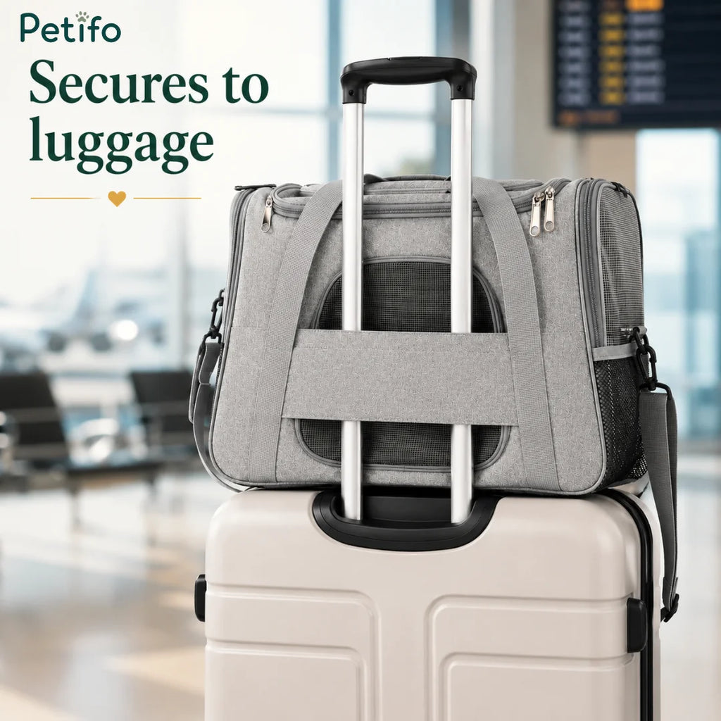 Petifo grey pet carrier conveniently secured over a rolling luggage handle at an airport terminal.