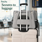 Petifo grey pet carrier conveniently secured over a rolling luggage handle at an airport terminal.