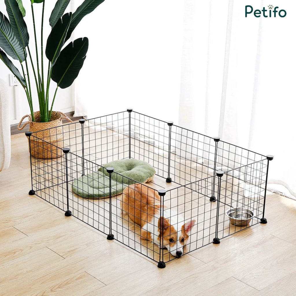 Corgi resting inside a Petifo black wire dog playpen set up in a modern living room.