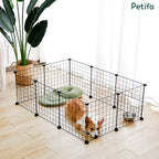 Corgi resting inside a Petifo black wire dog playpen set up in a modern living room.