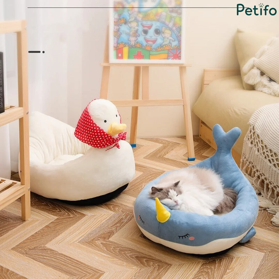 Cozy indoor pet setup featuring both the white duck and blue narwhal Petifo plush beds.