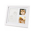 White wooden pet memory keepsake frame featuring clay paw prints and dual photo slots displaying a cute cat.