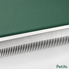 Macro close-up shot highlighting the fine, durable stainless steel teeth of the green pet grooming comb.
