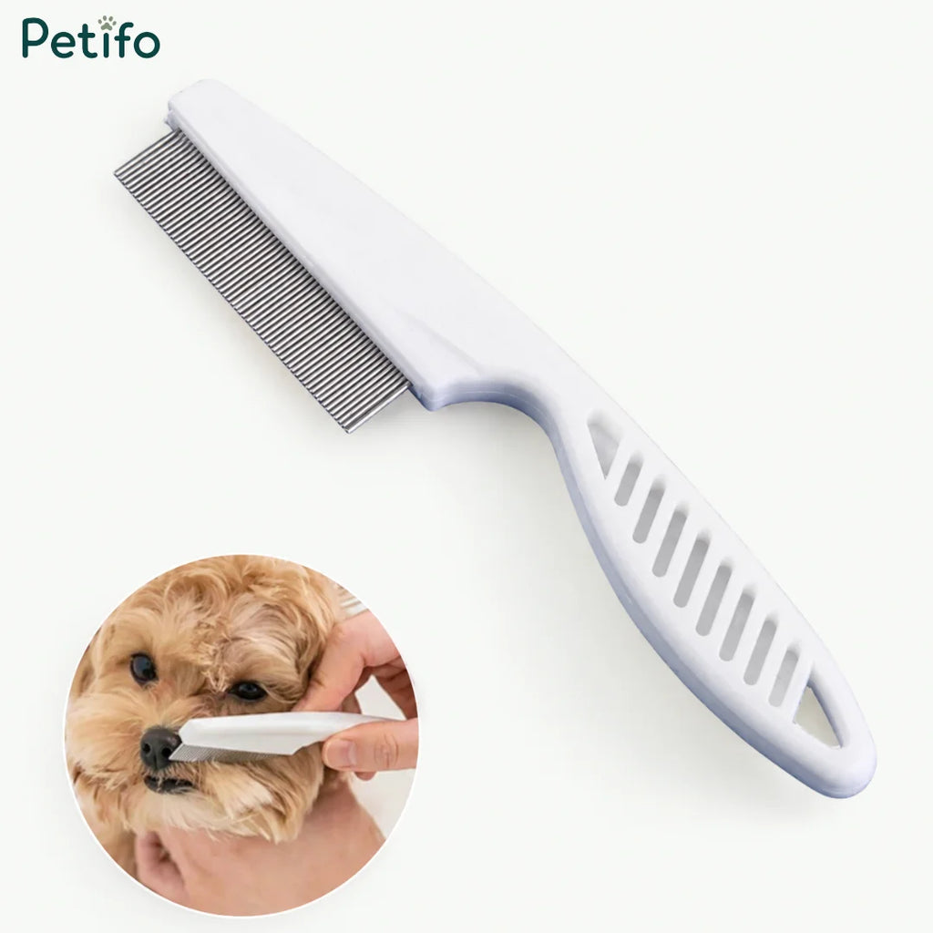Fine-toothed flea and tick grooming comb being used on a small dog's face.