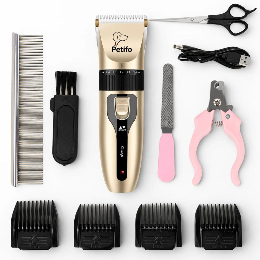 Flatlay arrangement of the gold pet grooming clipper and all included maintenance accessories.