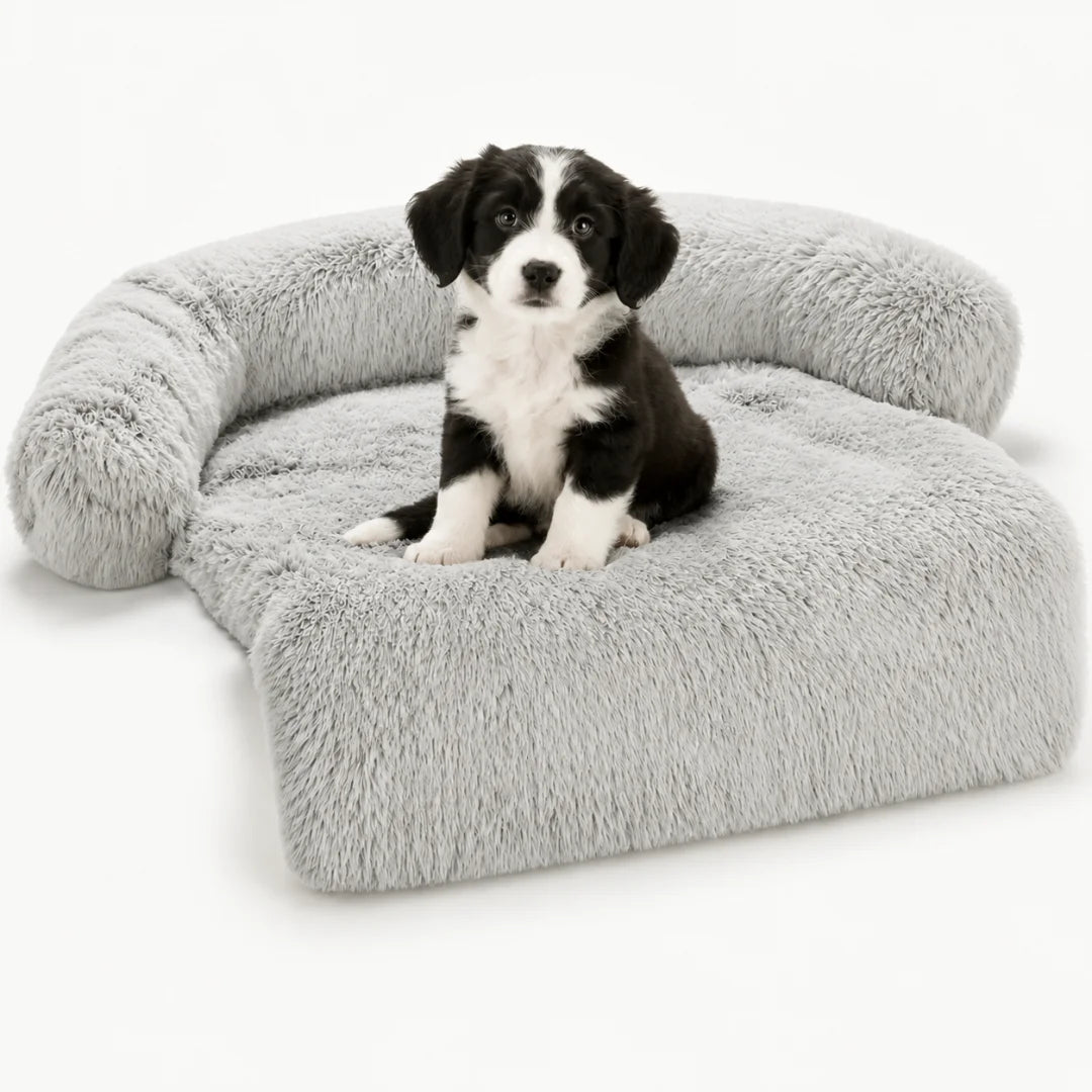 Fluffy grey pet sofa bed with a cute black and white puppy sitting proudly inside.