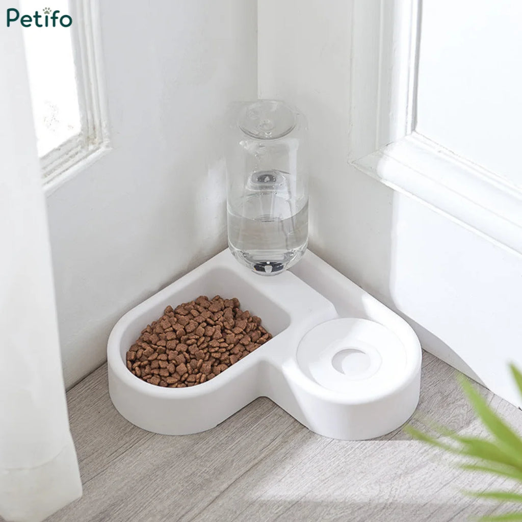 White Petifo corner pet feeding station filled with kibble and featuring an integrated water bottle.