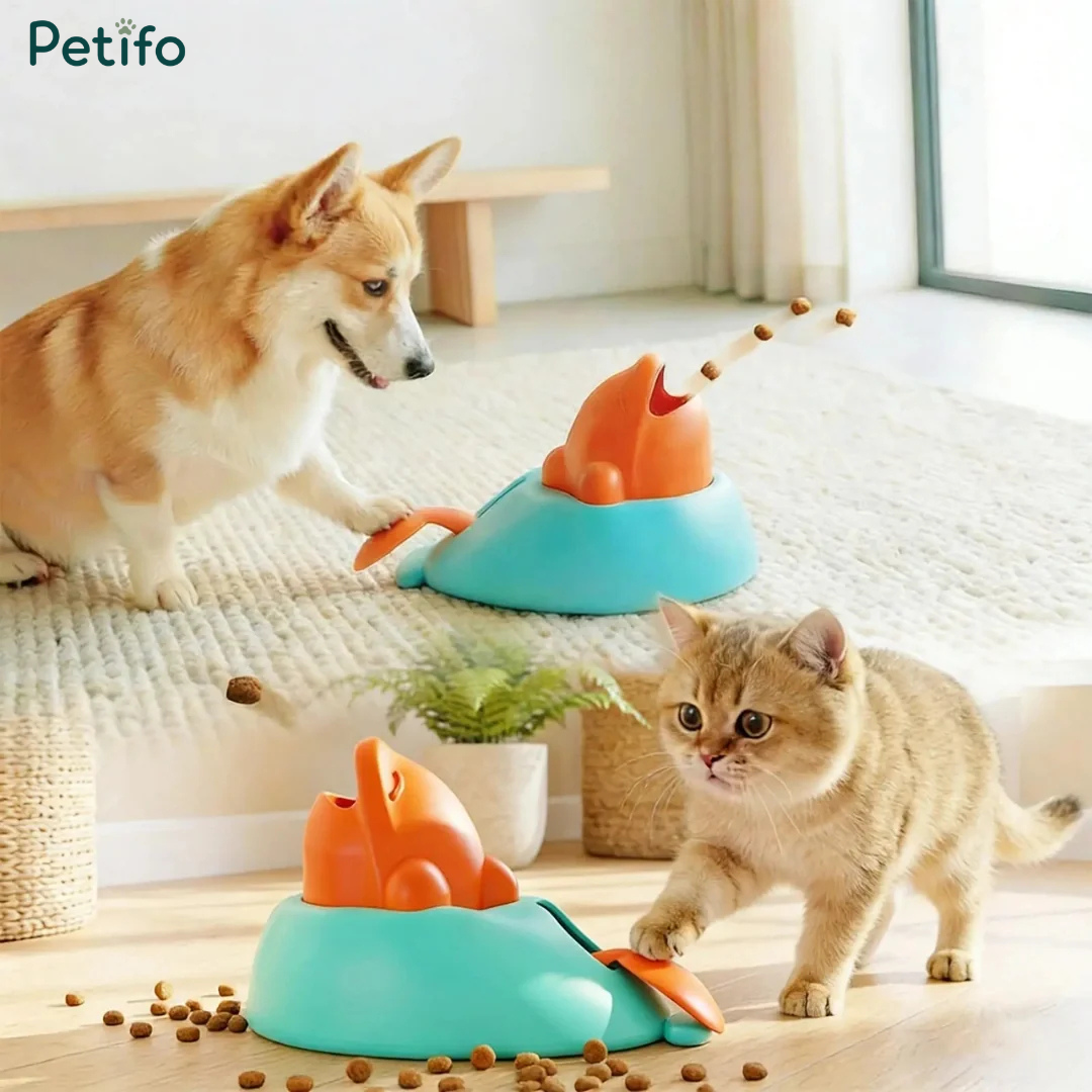 Corgi dog and kitten interacting with the Petifo interactive treat launcher puzzle toy as dry food flies out on a carpeted floor.