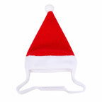 Red and white plush pet Santa hat with a white pom-pom on an isolated background.