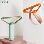 Studio product display showing a mint green lint remover on a podium alongside a floating peach variant.