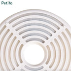 Close-up view of a circular white multi-stage pet water fountain filter element.