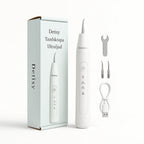Product packaging and unboxing layout showcasing the white Detixy ultrasonic dental scaler device alongside its branded box, replacement cleaning tips, a tightening wrench, and a USB charging cable.