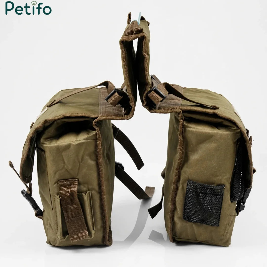 Pair of olive green canvas saddle bags shown against a white background.