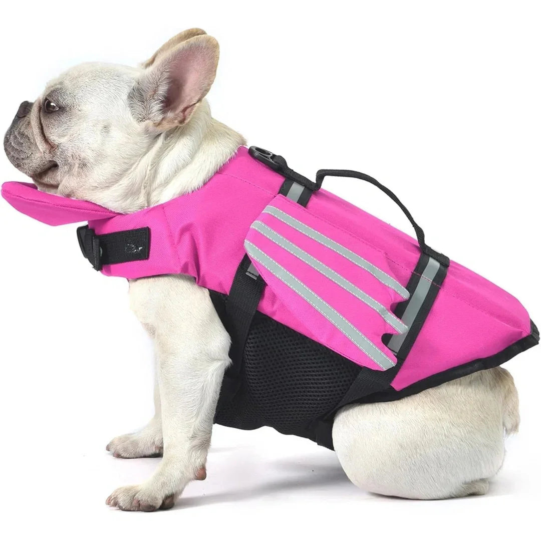 Side profile view of a French Bulldog modeling a hot pink dog life jacket with a front buoyancy chin rest and mesh underbelly.
