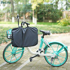 Petifo portable dog playpen packed inside a black travel bag resting on a bicycle basket outdoors.