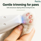 Macro shot showing precise trimming of long fur around a cat's paw pads without harming the skin.