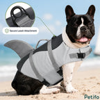 Petifo shark dog life jacket showing a secure leash attachment on a French Bulldog sitting on the beach.