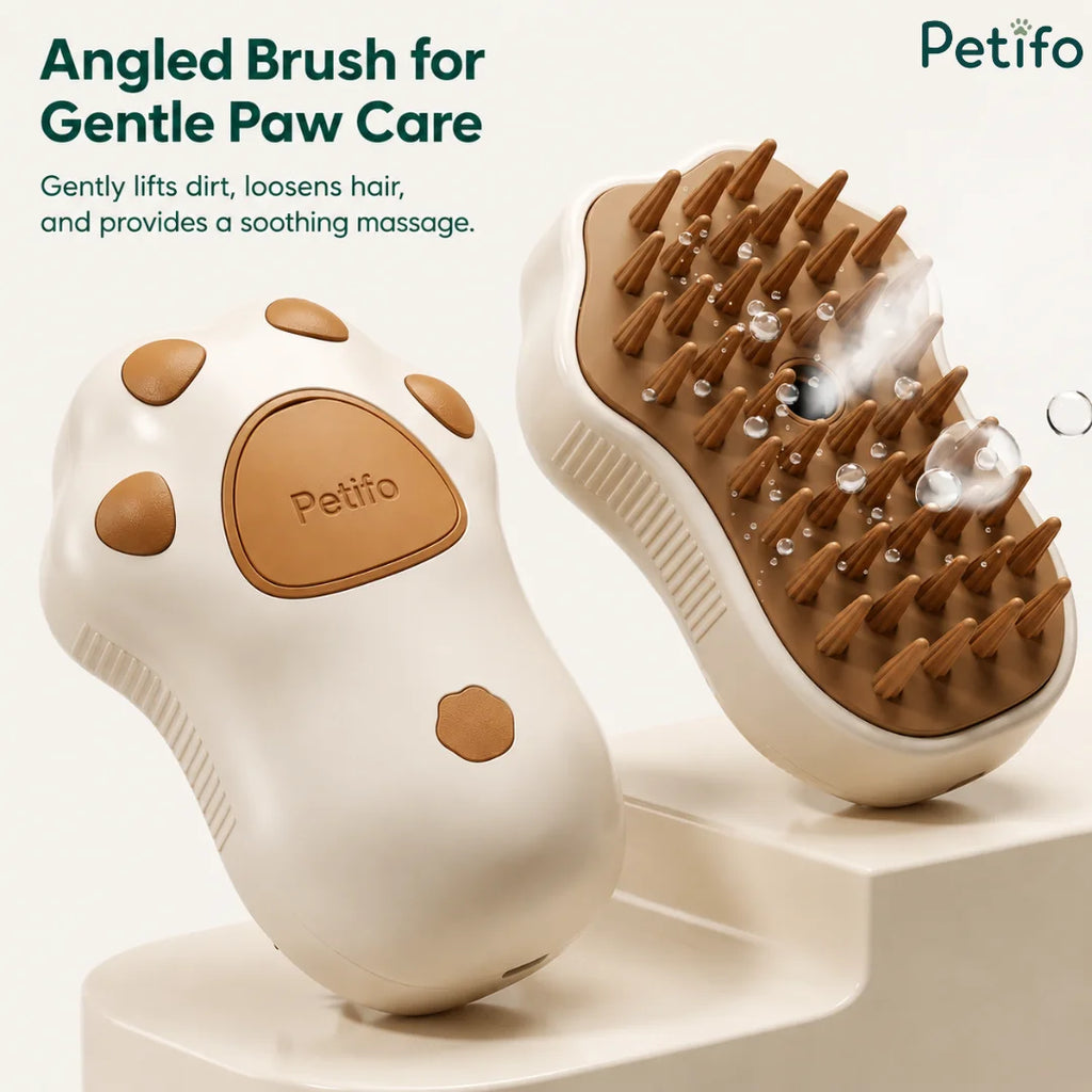 An angled view of the paw-shaped grooming brush highlighting its soft bristles, steam function, and ergonomic design.