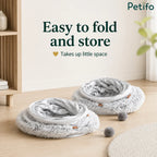 Two folded gray donut cat beds stacked neatly on a wooden floor to demonstrate space-saving storage.