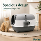 Large cat sitting next to the spacious grey and white enclosed litter box featuring height and length dimension markers.