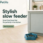 Teal Petifo slow feeder bowl filled with food placed on kitchen floor