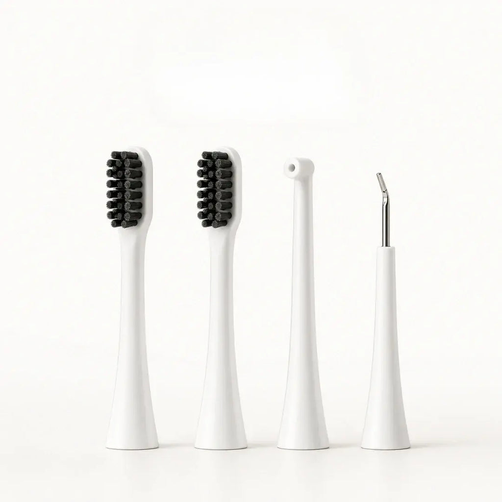 Four white replacement attachment heads for a dog electric toothbrush including two brush heads, a water flosser nozzle, and a scraper.