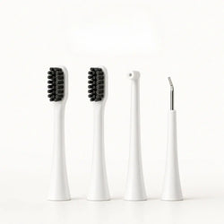 Four white replacement attachment heads for a dog electric toothbrush including two brush heads, a water flosser nozzle, and a scraper.