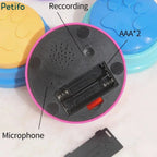 Underside view of a pink pet training buzzer highlighting the battery compartment, recording button, and microphone.