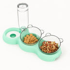 Green Petifo cat feeding station filled with dry food snacks and treats in its dual bowls.