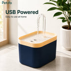 USB-powered Petifo automatic cat water fountain operating on a tabletop next to a potted plant.