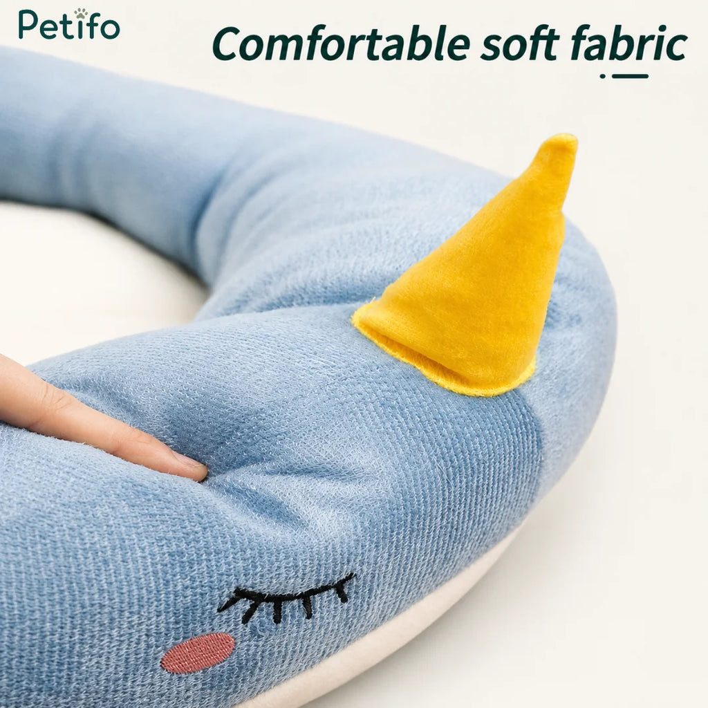 Close-up view of the ultra-soft, comfortable fabric and embroidered details on the Petifo narwhal pet bed.