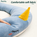 Close-up view of the ultra-soft, comfortable fabric and embroidered details on the Petifo narwhal pet bed.