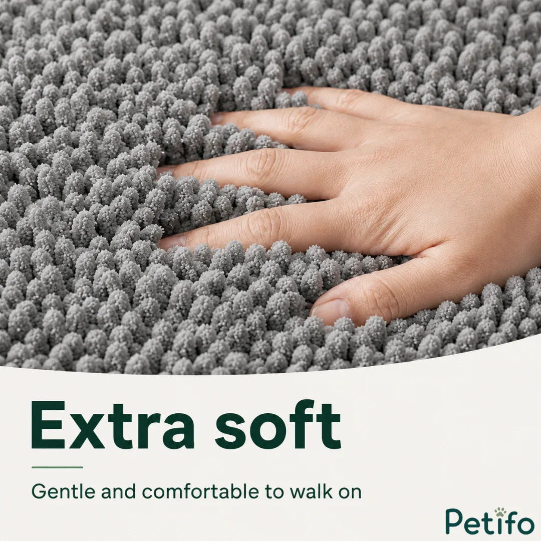 Close-up of a hand resting on the ultra-soft grey chenille fabric that provides gentle comfort for paws.
