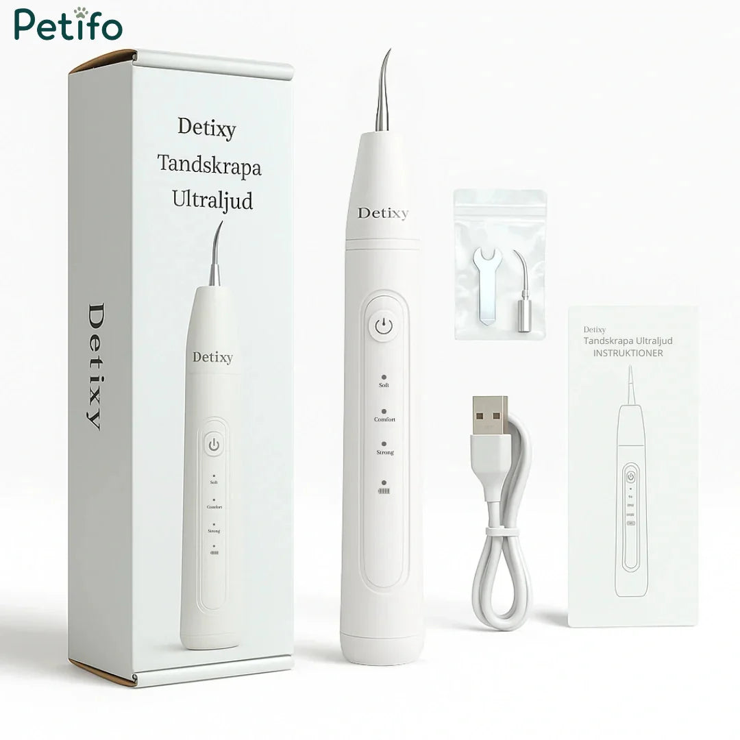 Unboxing layout displaying the Petifo Detixy Ultrasonic Dental Scaler device alongside its product box, replacement cleaning tips, a tightening tool, a USB charging cable, and an instruction manual.