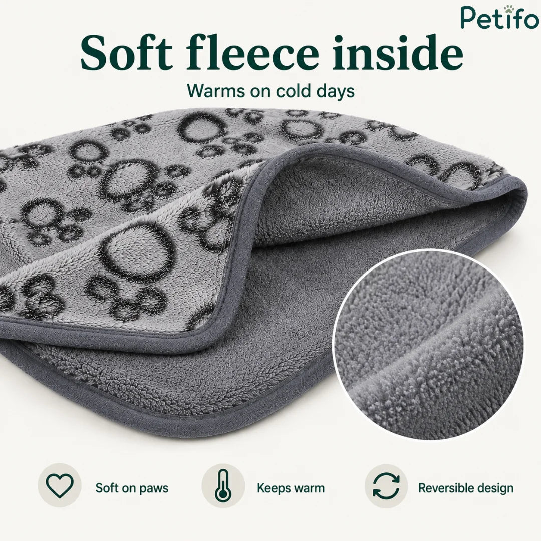 Close-up of a soft grey fleece pet blanket highlighting its warm plush interior and reversible design.