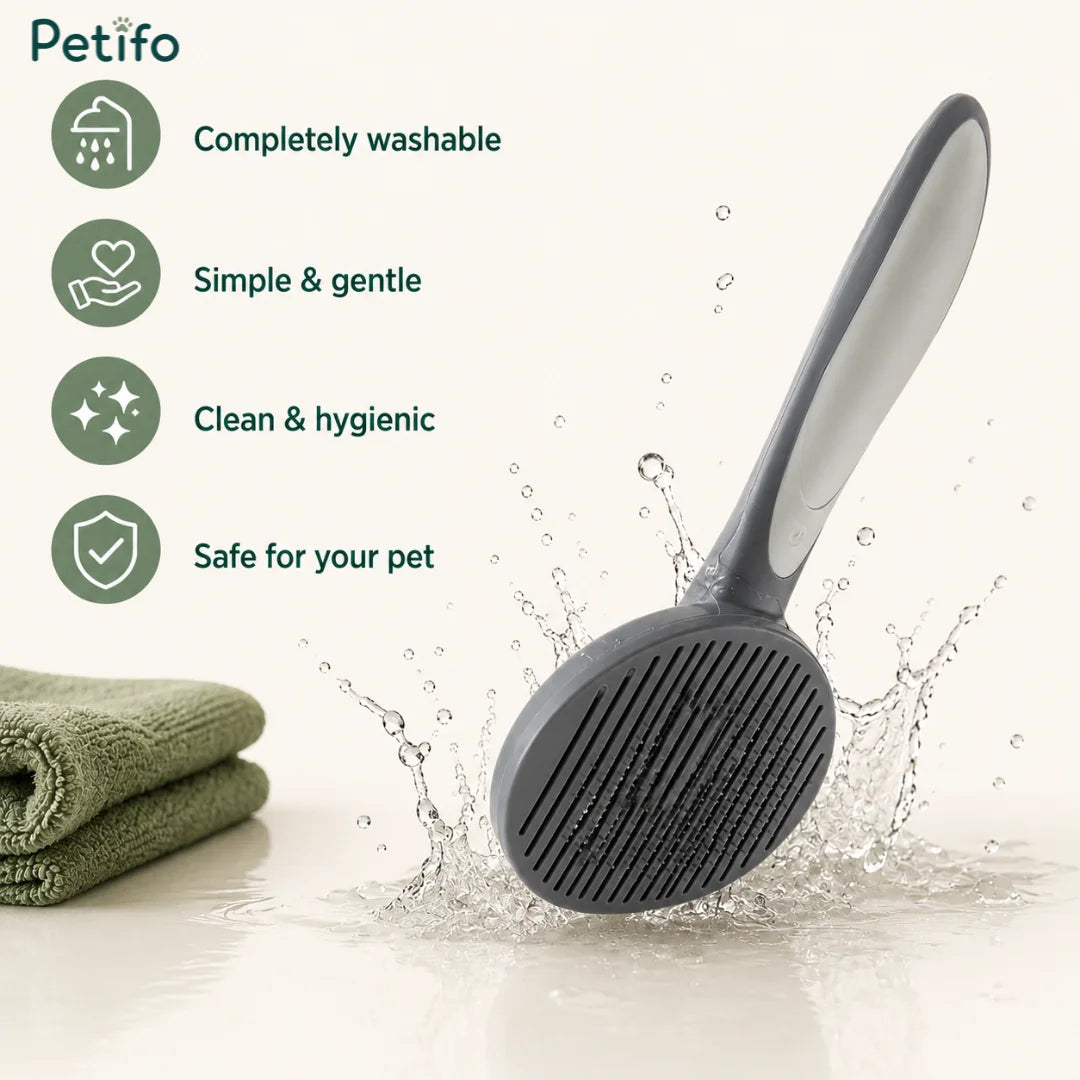Petifo self-cleaning pet slicker brush shown next to a folded green towel, highlighting its completely washable, gentle, clean, and safe design.