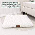 Fluffy white rectangular pet bed displayed on a carpeted floor with text regarding compression recovery.