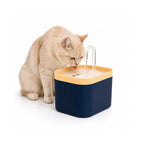 Yellow and blue Petifo automatic cat water fountain with a cat enjoying fresh water from the spout.