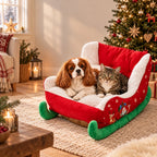 Dog and cat resting in the Christmas sleigh pet bed